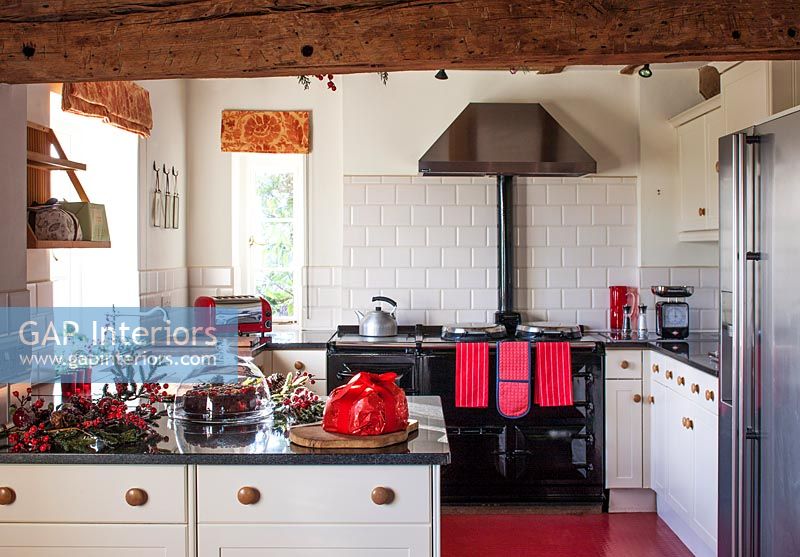Red, white and black country kitchen with Aga