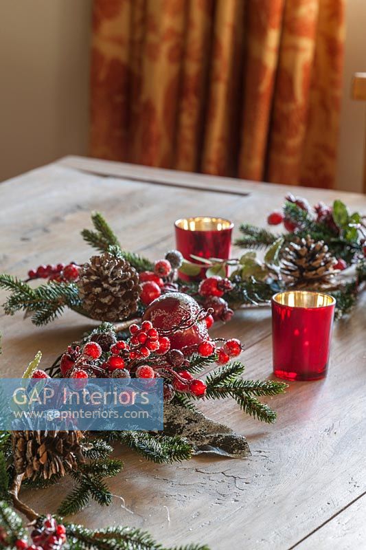 Christmas decorations on wooden table with candles 