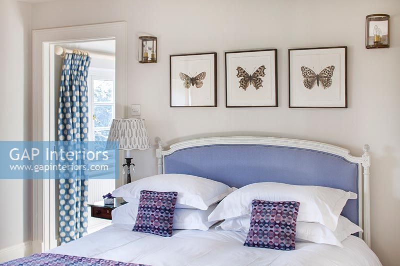 Butterfly paintings over lilac bed 