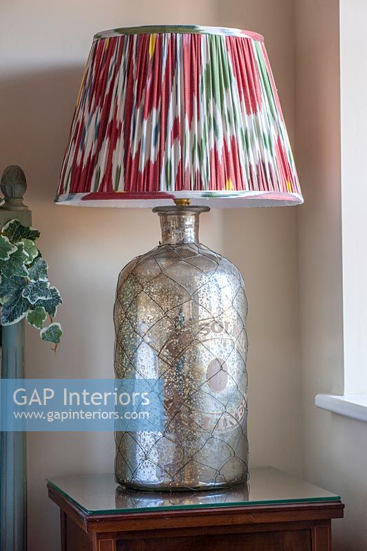 Colourful lampshade on metallic lamp 
