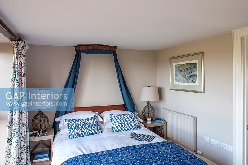Classic bedroom with blue bedding and drapes 