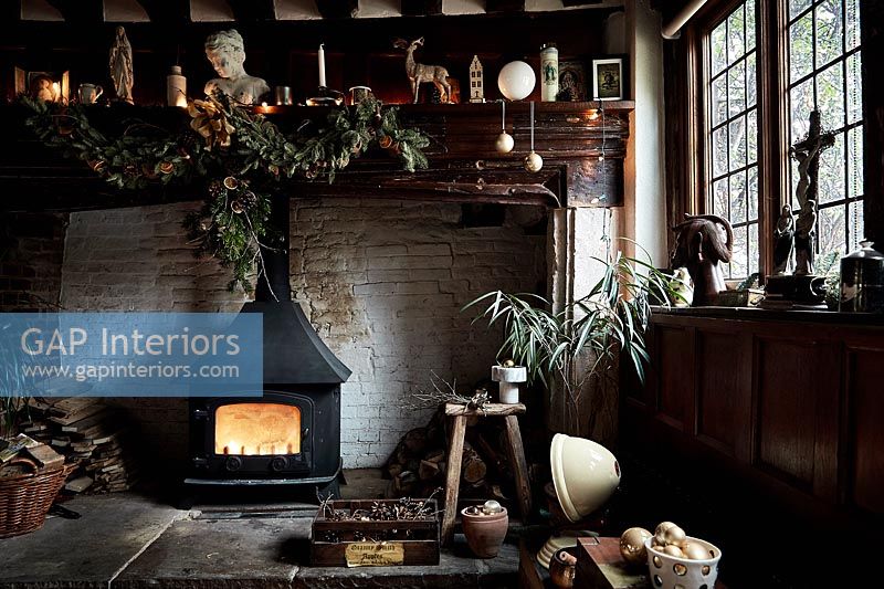 Large fireplace with wood burning stove and Christmas decorations 