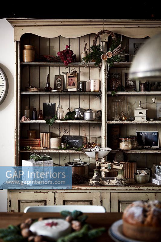 Large wooden dresser in country kitchen with Christmas decorations 