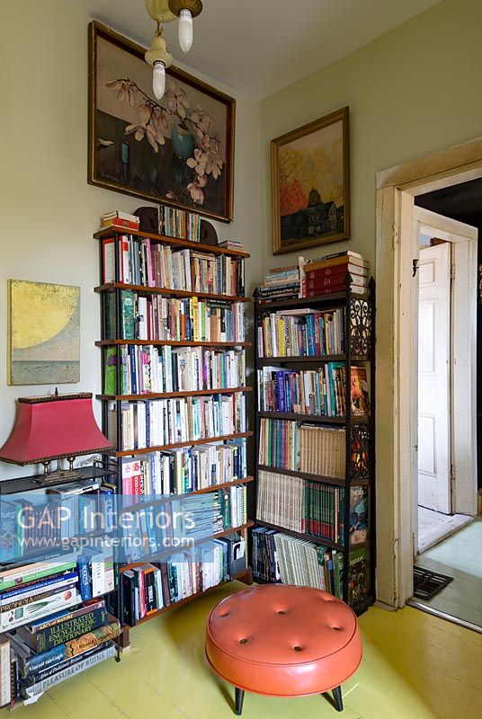 Bookcase in library with yellow painted floor