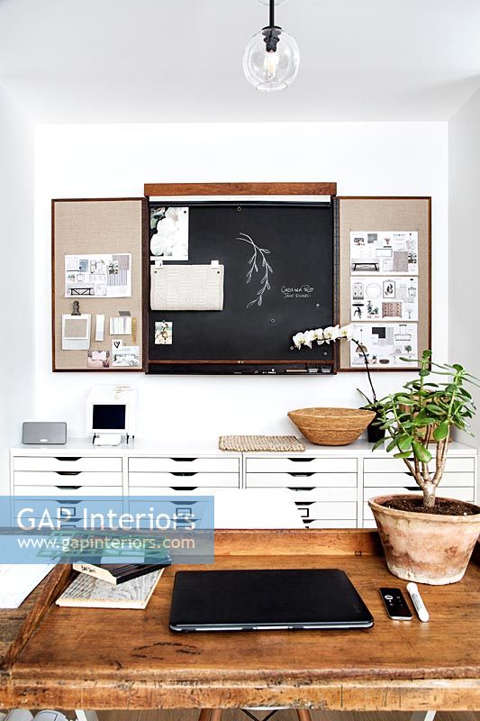 Large black and white drawers and blackboard in modern study 