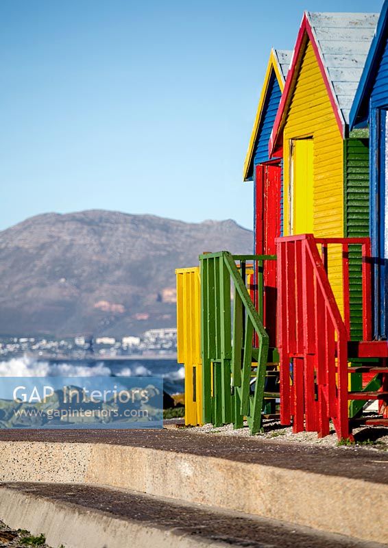 Colourful beach huts and coastal view 