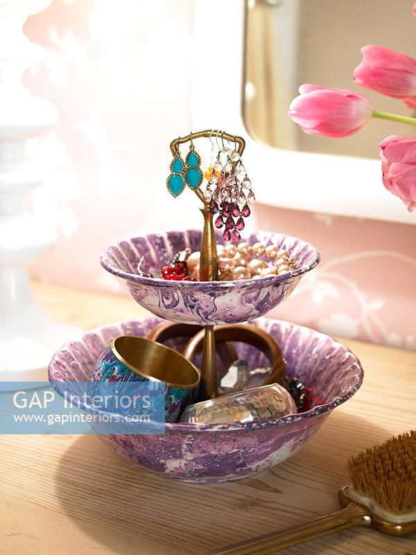 Decorative bowl of jewelry on dressing table 