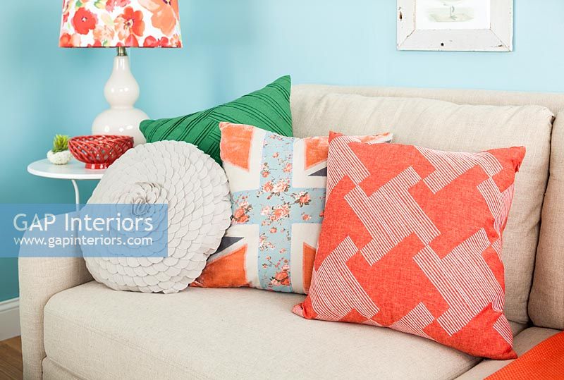 Variety of colourful cushions on sofa in modern living room 