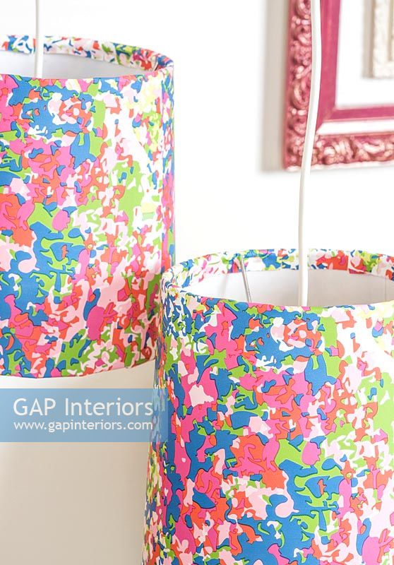 Colourful lampshades created using wallpaper to cover them
