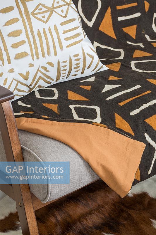 Patterned throw and cushion on sofa 