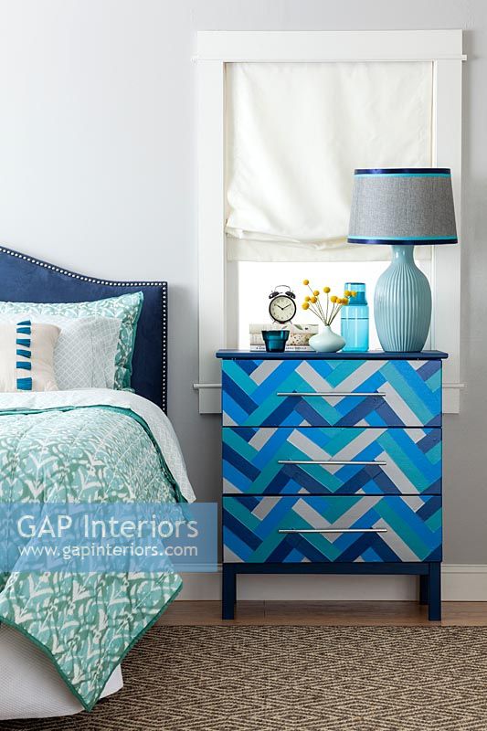 Blue patterned chest of drawers in modern bedroom 