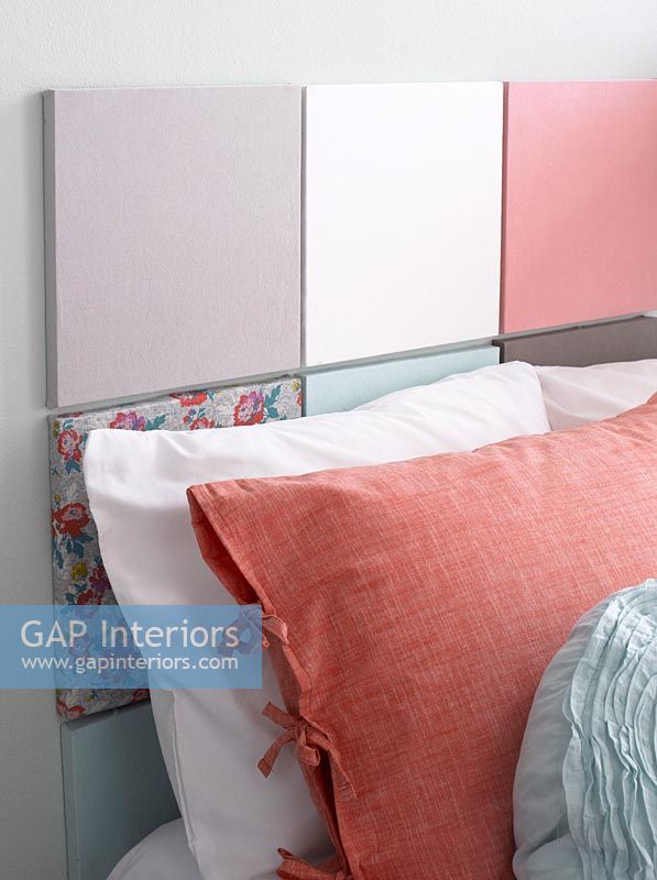 Colourful headboard made from square panels covered in t-shirt fabric 