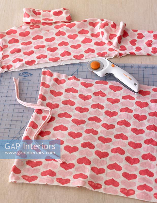 Heart patterned roll neck top on cutting board 