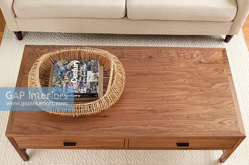 Wooden coffee table and basket of books 