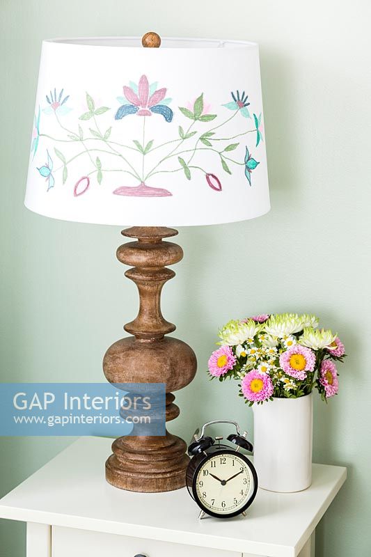 Arts and crafts style lampshade on bedside table 