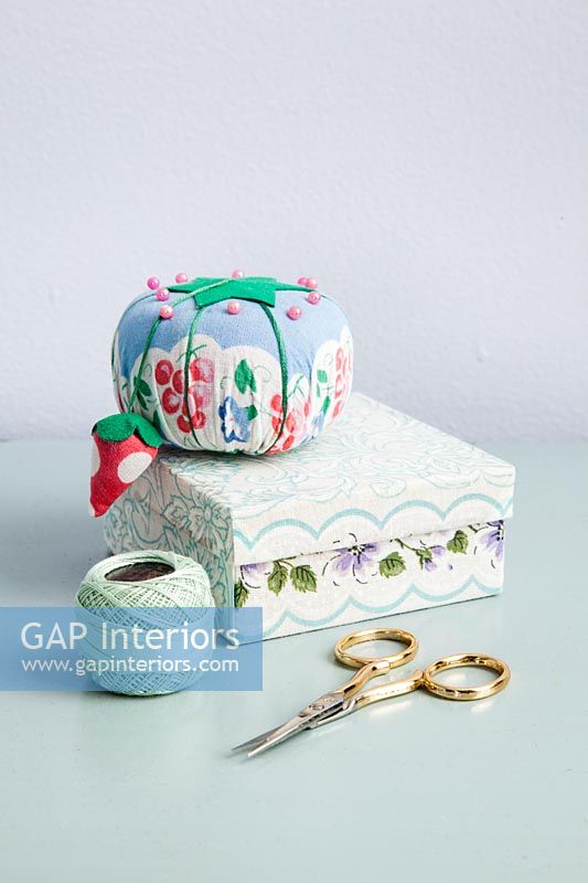 Pin cushion on sewing box with accessories 