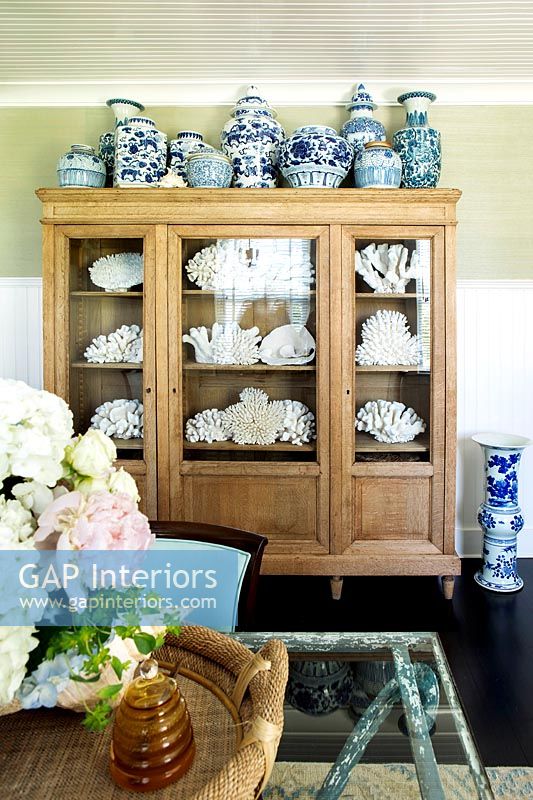 Wooden vitrine cabinet filled with ceramics 