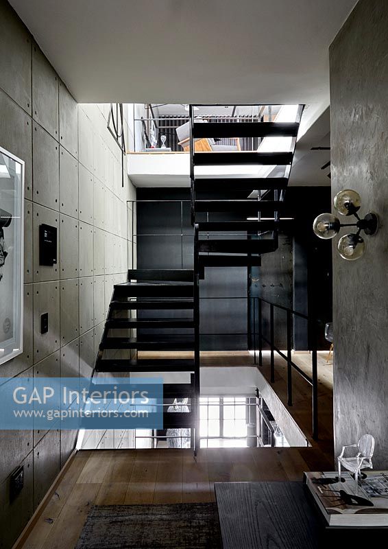 View of black metal staircase in industrial home 