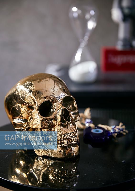 Gold skull ornament on black table 