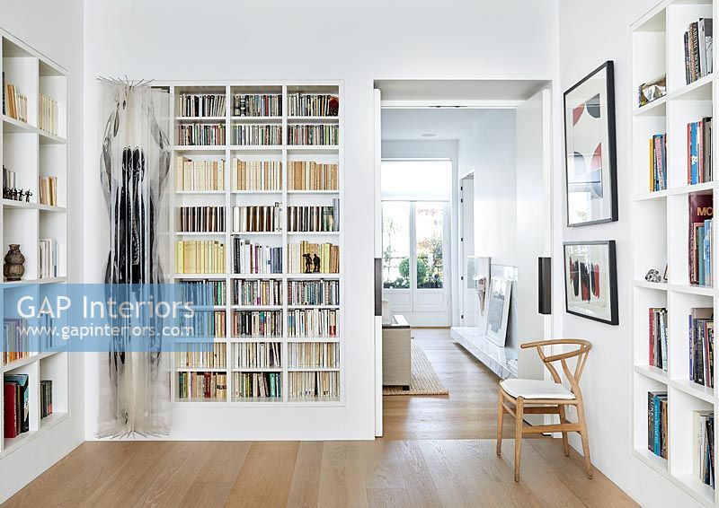 Modern reading room with alcove shelving wall to wall 