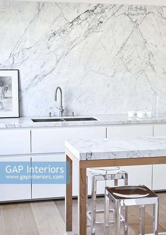 Marble splash back and worktops in white modern kitchen 