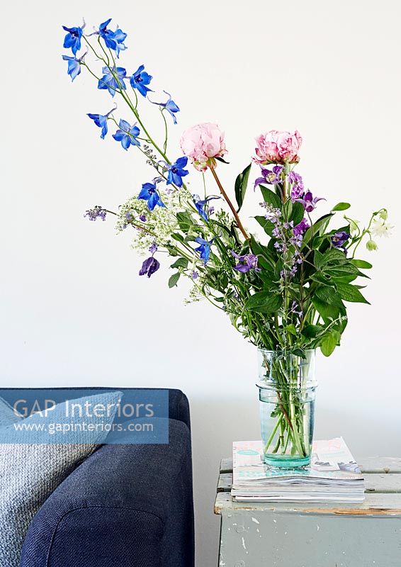 Vase of flowers on wooden side table 