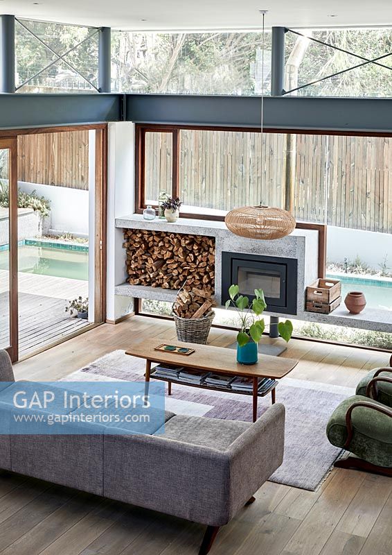 Modern glazed living room with wood burning stove 