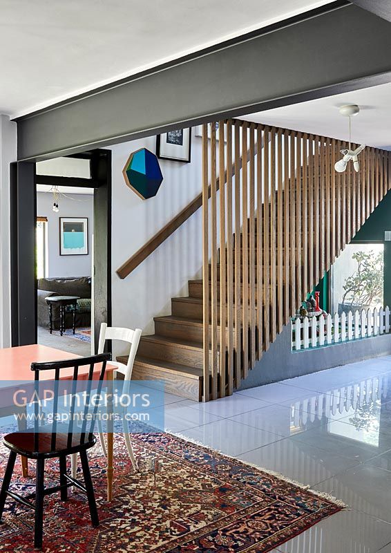 Slatted wooden staircase in modern open plan living space 