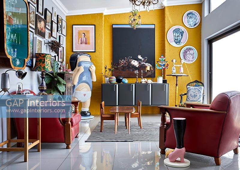 Eclectic living room with yellow painted feature wall 