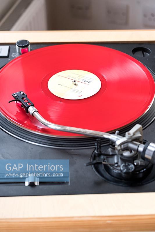 Red vinyl record on turntable 