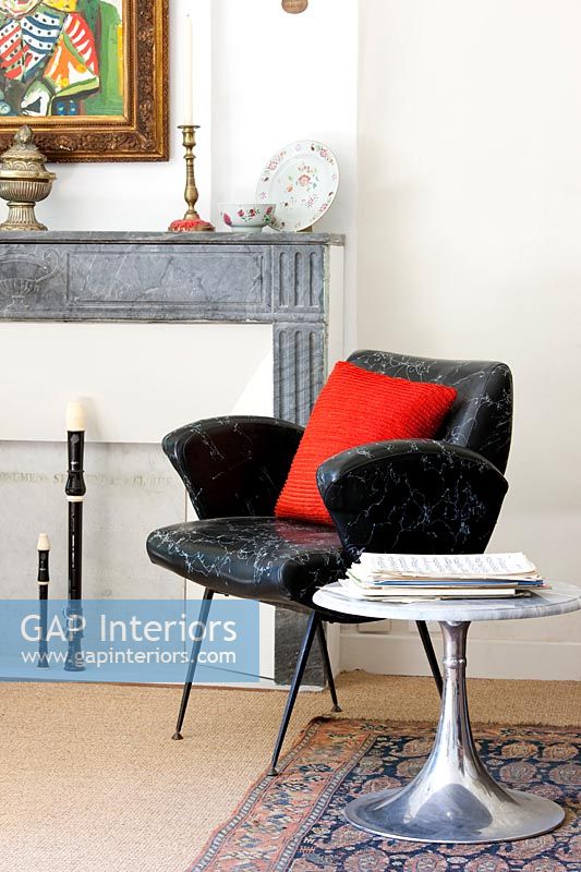 Black vintage armchair and silver table with marble top 