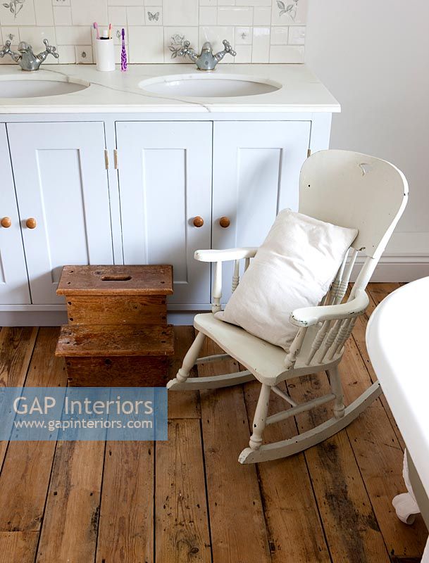 Rocking chair and step for child in country bathroom 