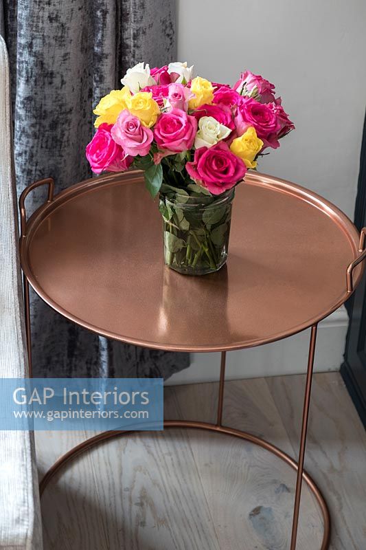 Vase of roses on copper table 