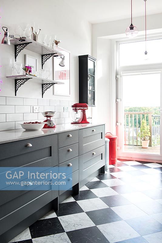 Modern grey kitchen with red accessories 