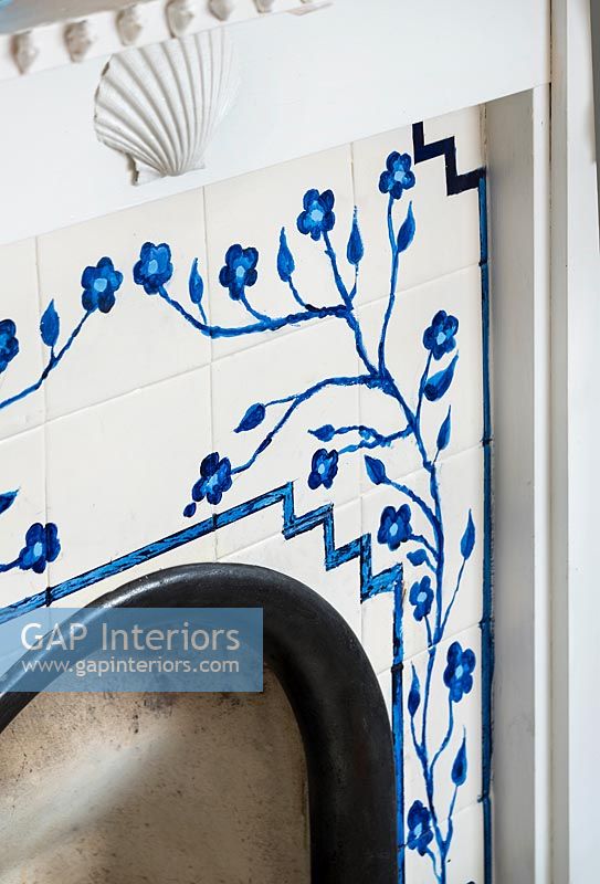 Blue and white decorative tiling in fireplace 