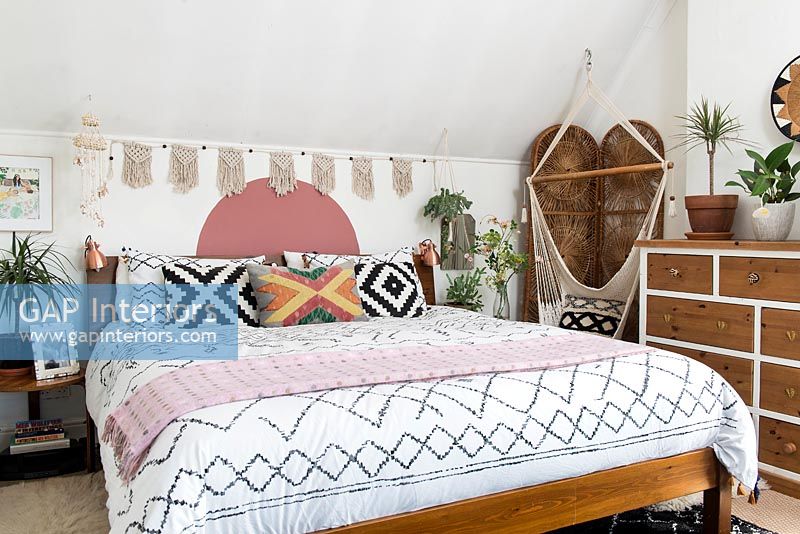 Eclectic bedroom with macrame swing seat 