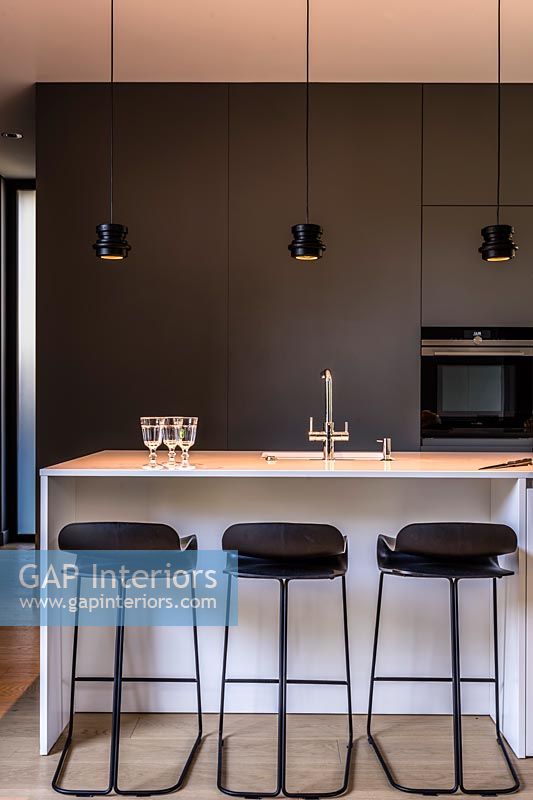 Contemporary monochrome kitchen with lights on 