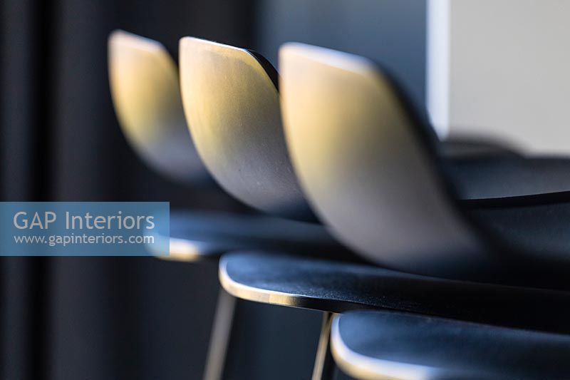 Row of black bar stools - detail 