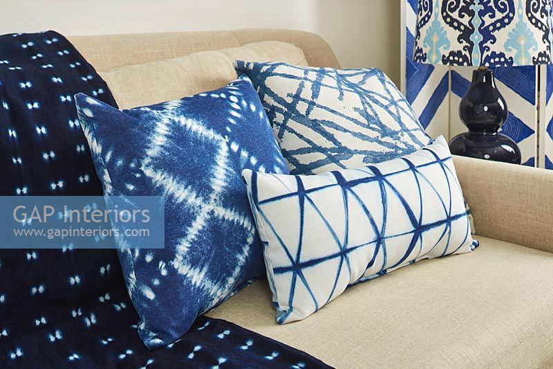 Various blue and white cushions on sofa 