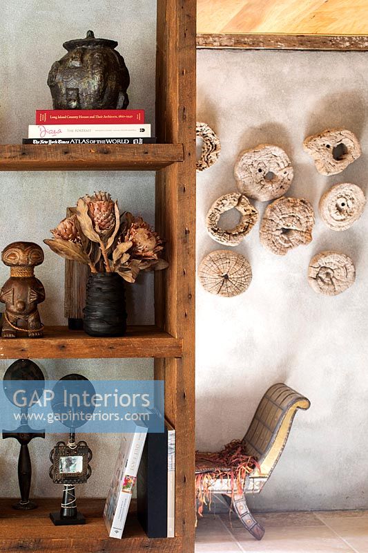 Wooden bookcase with rustic ornaments and dried flowers 