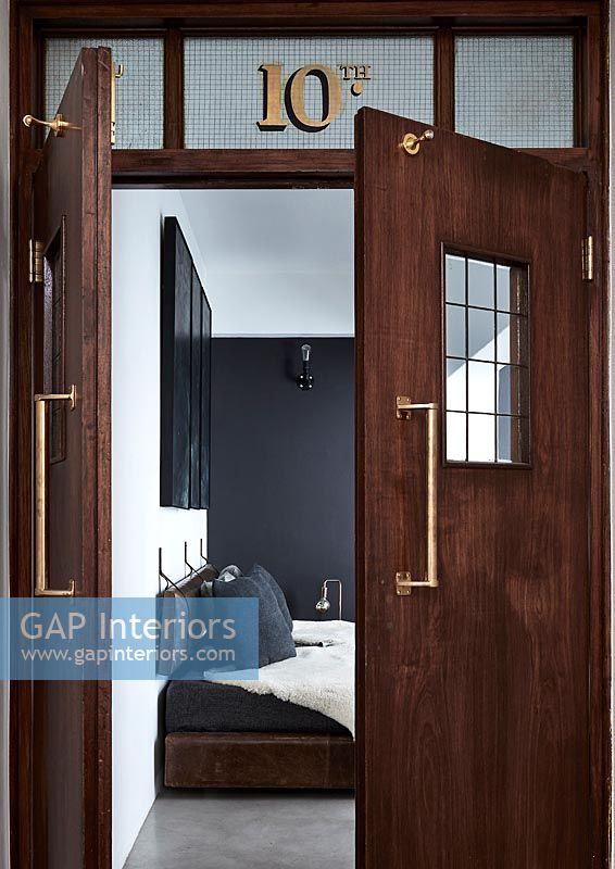 Wooden double doors to modern monochrome bedroom 
