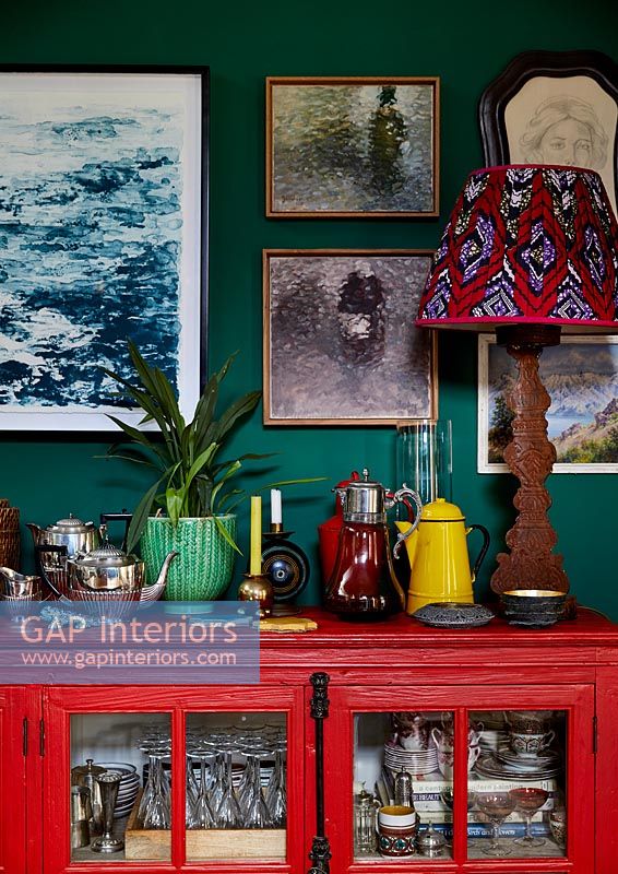 Bright red dresser with tea and coffee pots display 