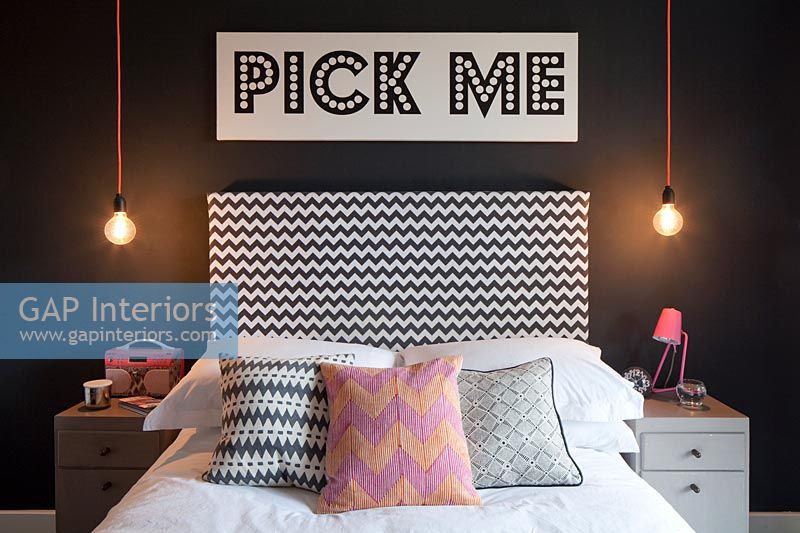 Modern bedroom with Pick Me sign above the bed