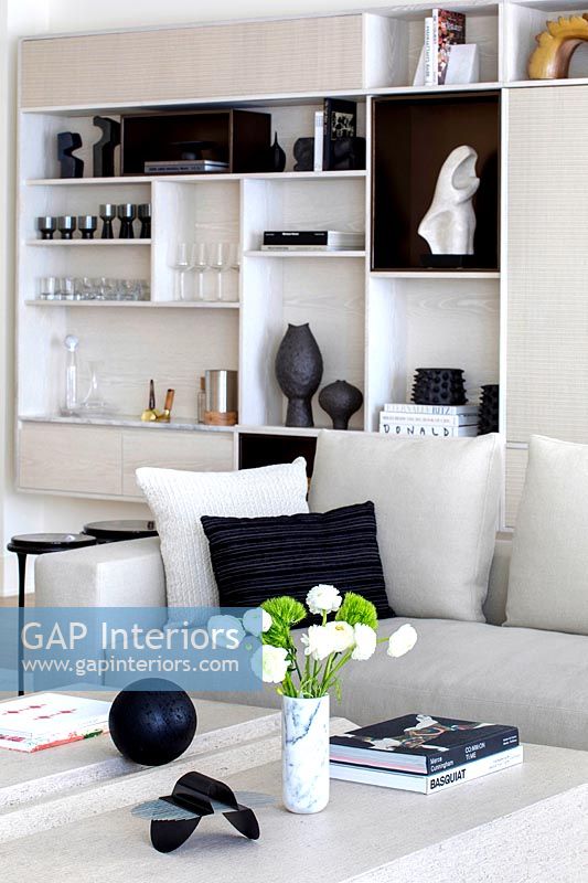 Modern white sofa and built-in shelving unit 