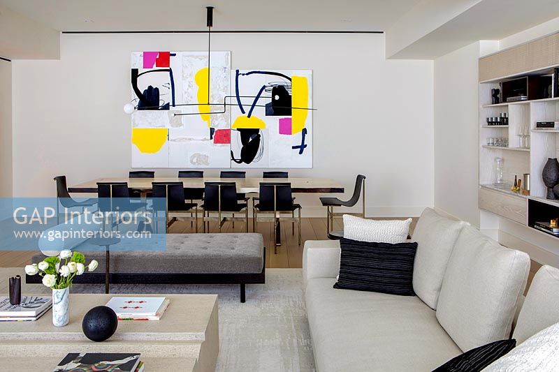 Colorful modern painting in dining area of open plan living space 