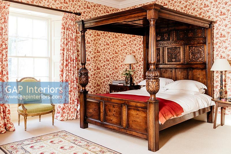 Bedroom with large wooden four poster bed 