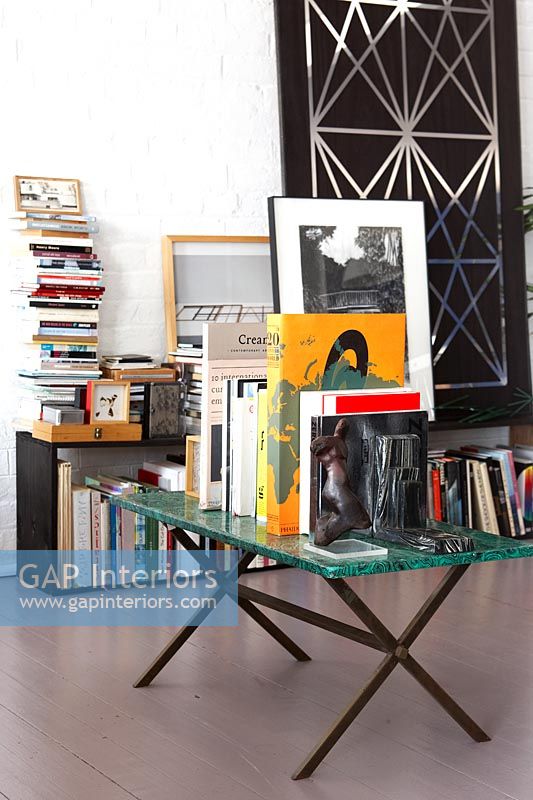 Books and artwork on table and bookcases 