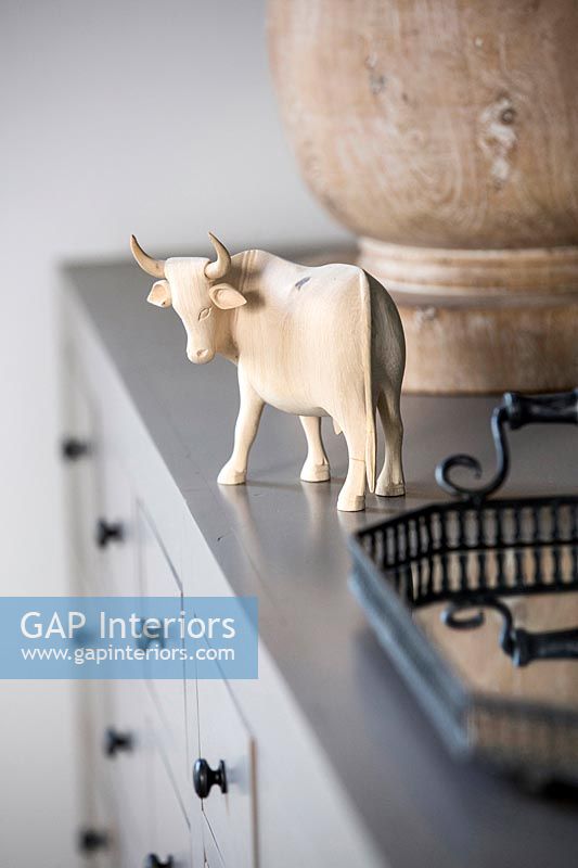 Wooden carving of oxen on sideboard 