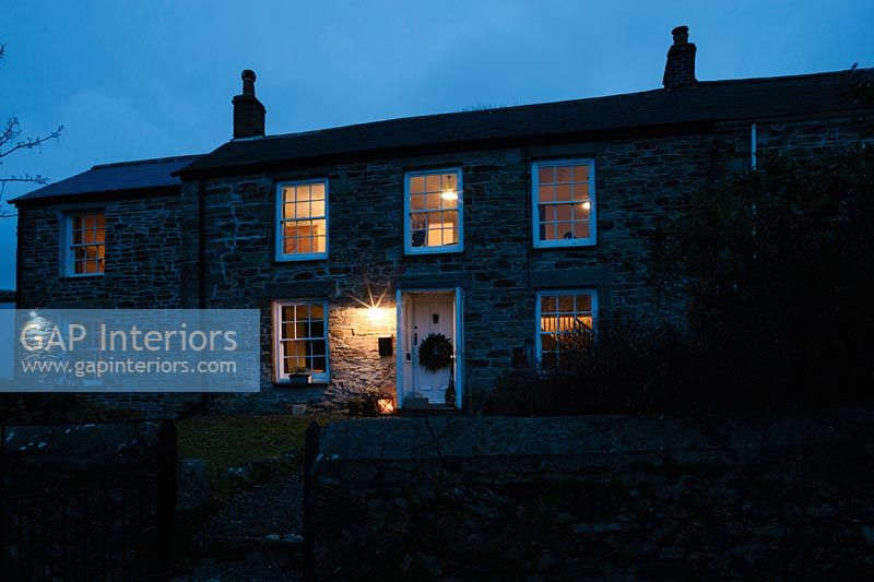 Cornish cottage at night decorated for Christmas