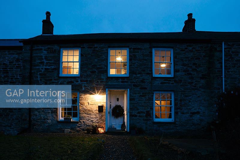 Cornish cottage at night decorated for Christmas